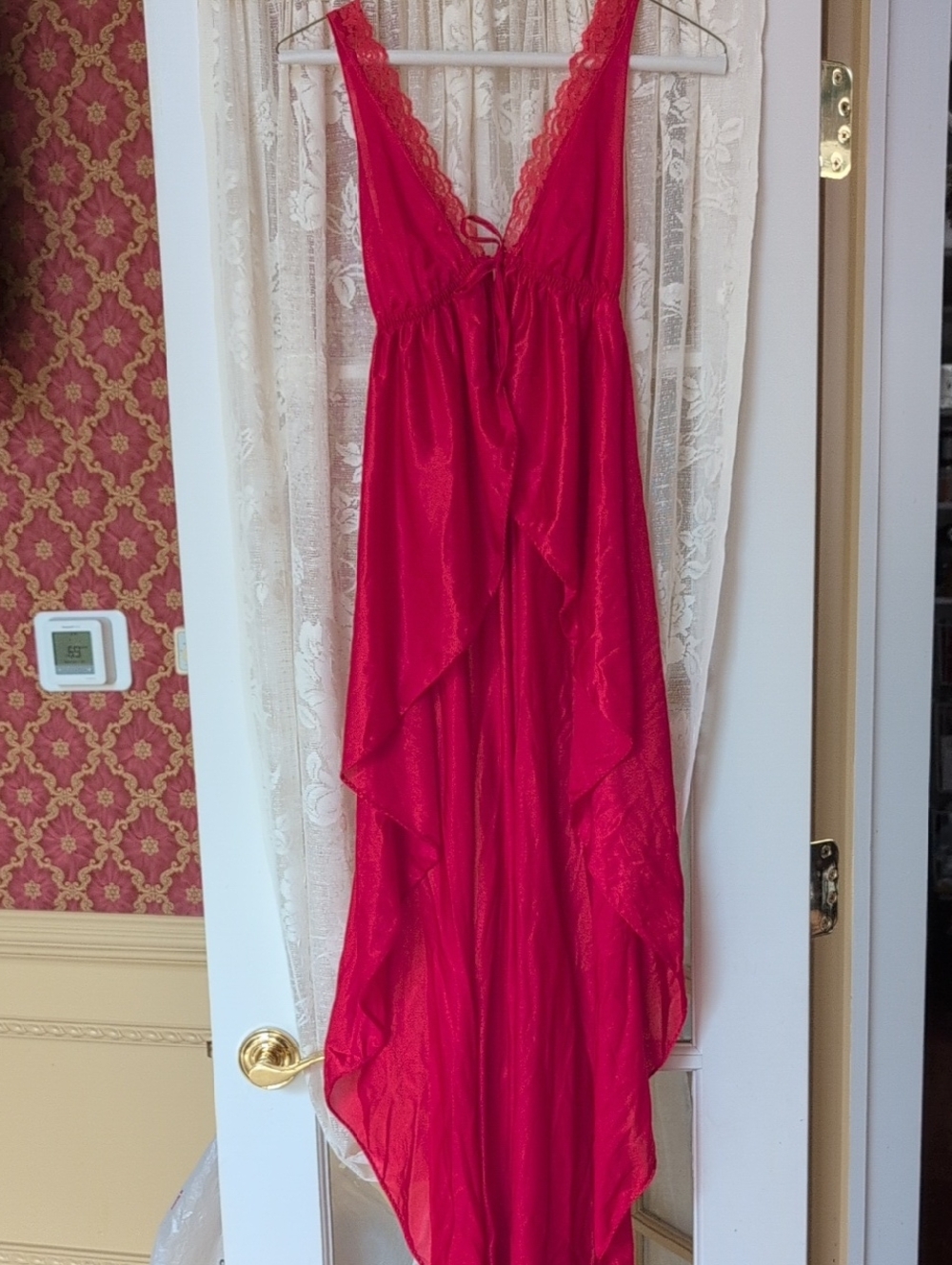 A Red Low Plunging Night Gown That Is Open From The Bust Down With G String Pant